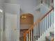 Entryway with staircase featuring wood railing and neutral walls, leading to dining room at 2015 Aldbury Ln, Woodstock, GA 30189