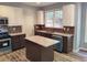 This kitchen offers stainless steel appliances, an island, and two-tone cabinetry at 2015 Aldbury Ln, Woodstock, GA 30189