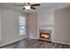 Inviting living room featuring a fireplace, ceiling fan and vinyl flooring at 2015 Aldbury Ln, Woodstock, GA 30189