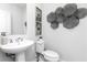 Stylish half bathroom with a pedestal sink, modern decor, and contemporary fixtures at 337 Skylar Se Way, Atlanta, GA 30315