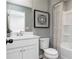 Cozy bathroom with decorative shower curtain, white vanity, and modern decorative art at 337 Skylar Se Way, Atlanta, GA 30315