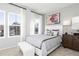 Sunlit bedroom with large windows, elegant curtains, a cozy bed, and a decorative wooden cabinet at 337 Skylar Se Way, Atlanta, GA 30315