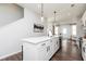 Bright kitchen features an island with quartz countertop, modern fixtures, and stainless steel appliances at 337 Skylar Se Way, Atlanta, GA 30315