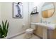 Elegant bathroom featuring a pedestal sink, decorative mirror, and stylish artwork for a modern touch at 400 Village Ne Pkwy # 114, Atlanta, GA 30306