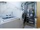 Functional laundry room with washer, dryer, and shelving for organized storage at 400 Village Ne Pkwy # 114, Atlanta, GA 30306