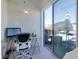 Bright office space with glass desk and a sliding glass door to the outside balcony at 400 Village Ne Pkwy # 114, Atlanta, GA 30306