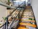 Unique staircase design with wood steps and metal railing, leading to the open living space at 400 Village Ne Pkwy # 114, Atlanta, GA 30306