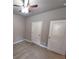 Bedroom with carpet flooring, ceiling fan, and two doors at 42 Champions Crossing, Villa Rica, GA 30180