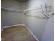 Walk-in closet featuring metal shelves with carpeted flooring at 42 Champions Crossing, Villa Rica, GA 30180