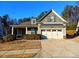 Charming exterior view showcasing the home's architectural details and well-maintained landscaping at 42 Champions Crossing, Villa Rica, GA 30180