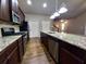 Modern kitchen with stainless steel appliances and granite countertops open to the living area at 42 Champions Crossing, Villa Rica, GA 30180