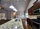 Bright kitchen with stainless appliances, granite countertop, and view to the living area at 42 Champions Crossing, Villa Rica, GA 30180