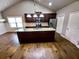 Bright kitchen showcasing a granite island, stainless appliances, and hardwood floors at 42 Champions Crossing, Villa Rica, GA 30180