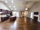 Open-concept living room with hardwood floors, fireplace, and open kitchen at 42 Champions Crossing, Villa Rica, GA 30180