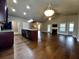Open-concept living room with fireplace and kitchen island featuring granite countertops at 42 Champions Crossing, Villa Rica, GA 30180