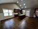 Open-concept living room and kitchen with hardwood floors and bright, natural lighting at 42 Champions Crossing, Villa Rica, GA 30180