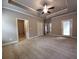 Spacious carpeted main bedroom with tray ceiling, fan, and access to a door leading to the backyard at 42 Champions Crossing, Villa Rica, GA 30180