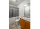 Bathroom featuring a shower with gray curtain, a toilet and a single sink vanity with neutral tile flooring at 15 Corinth Rd, Cartersville, GA 30121