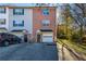 Brick and siding townhome with attached garage, double front doors, and a well-maintained driveway, surrounded by trees at 15 Corinth Rd, Cartersville, GA 30121