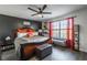 Inviting main bedroom with a large bed, accent wall, and natural light from the window with red drapes at 15 Corinth Rd, Cartersville, GA 30121