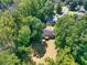 Aerial view of home with large backyard, wooden deck, and surrounding mature trees at 1875 Creekside Ct, Decatur, GA 30032