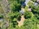 Aerial view of a home with a spacious yard surrounded by a dense canopy of trees at 1875 Creekside Ct, Decatur, GA 30032