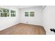 Bright bedroom featuring wood-look flooring and two windows at 1875 Creekside Ct, Decatur, GA 30032