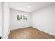 Bright bedroom featuring wood-look flooring, a window, and neutral walls at 1875 Creekside Ct, Decatur, GA 30032