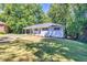 Quaint home with a light-colored exterior, carport, and a well-kept lawn at 1875 Creekside Ct, Decatur, GA 30032