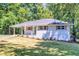 Charming, one-story brick home featuring a covered carport and inviting green front door at 1875 Creekside Ct, Decatur, GA 30032