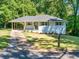 Inviting single-Gathering home featuring a covered carport and freshly manicured lawn at 1875 Creekside Ct, Decatur, GA 30032