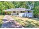 Inviting single-story home with a driveway and a covered carport on a landscaped lot at 1875 Creekside Ct, Decatur, GA 30032