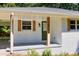 A view of the front porch with painted white brick and a green door at 1875 Creekside Ct, Decatur, GA 30032