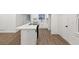 Kitchen featuring a breakfast bar with cooktop, white cabinets, and stainless appliances next to a door and window at 1875 Creekside Ct, Decatur, GA 30032