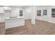 Open living space featuring wood floors, a kitchen island with cooktop, and lots of natural light from nearby windows at 1875 Creekside Ct, Decatur, GA 30032