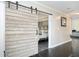 Bedroom entryway with decorative sliding barn door and view of the bed at 2541 Kickerillo Se Way, Atlanta, GA 30316