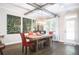 Bright dining room features an exposed beam ceiling, a rustic wood table, and modern light fixture at 2541 Kickerillo Se Way, Atlanta, GA 30316