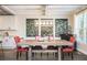 Open-concept dining room has a rustic wood table, red chairs, and large windows for natural light at 2541 Kickerillo Se Way, Atlanta, GA 30316