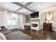 Comfortable living room with a fireplace, built-in shelves, and a large window for plenty of light at 2541 Kickerillo Se Way, Atlanta, GA 30316