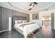 The main bedroom has tray ceilings, wood paneling, and a sliding barn door to the ensuite bathroom at 2541 Kickerillo Se Way, Atlanta, GA 30316