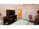 Bedroom includes a ceiling fan, a TV, and sliding closet doors at 3787 Vineyards Lake Nw Cir # 21, Kennesaw, GA 30144