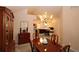 Elegant dining room featuring wooden furniture, chandelier lighting, and seamless flow into the kitchen, ideal for hosting at 3787 Vineyards Lake Nw Cir # 21, Kennesaw, GA 30144