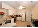 Well-lit kitchen featuring white cabinets, stainless steel appliances, and a ceiling fan at 3787 Vineyards Lake Nw Cir # 21, Kennesaw, GA 30144