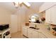 Kitchen with white cabinets, stainless steel sink, and connection to living area at 3787 Vineyards Lake Nw Cir # 21, Kennesaw, GA 30144