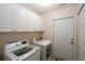 Convenient laundry room with a washer and dryer and plenty of cabinet storage space at 3787 Vineyards Lake Nw Cir # 21, Kennesaw, GA 30144