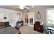 Versatile sun room featuring neutral walls, ample seating, and French doors leading to the interior of the house at 3787 Vineyards Lake Nw Cir # 21, Kennesaw, GA 30144