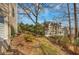 View of a backyard with a stone pathway and lush greenery leading up a gentle slope towards another home at 4753 Outlook Ne Way, Marietta, GA 30066