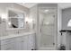 Bright bathroom featuring a modern vanity with white cabinets and a glass-enclosed shower with tiled walls at 4753 Outlook Ne Way, Marietta, GA 30066