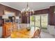 Dining room with wood table, wooden chairs, elegant lighting and natural light at 4753 Outlook Ne Way, Marietta, GA 30066