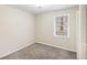 Cozy bedroom with plush carpeting, a window offering natural light, and a closet at 6510 Connell Rd, Atlanta, GA 30349